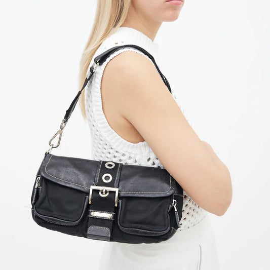 Woman carrying a black handbag on a white background